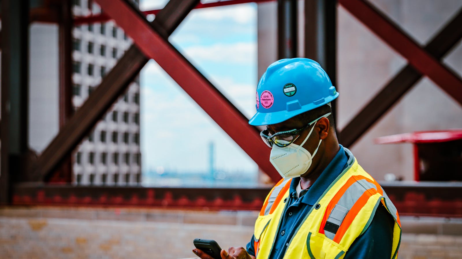 A contractor's phone ringing on a work truck dashboard with tools and a clipboard visible - capturing the choice between answering and finishing the job at hand.